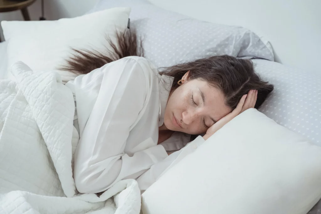 Woman sleeping comfortably: Why Do You Need A Mattress Cover For Allergy Symptom Prevention