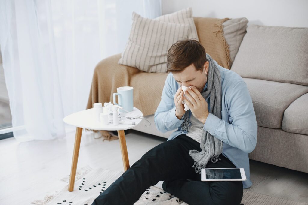 man sneezing because of flu or sinus infection